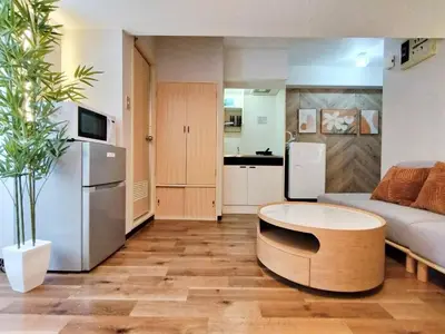 a living room with a couch and a table at G51\u65b0\u5bbf\u6700\u4e2d\u5fc3 \u6771\u65b0\u5bbf\u7ad95\u5206-Shinjuku center 5 mins to Station, Max 4P \u65b0\u5bbf \u6d89\u8c37 \u8868\u53c2\u9053 \u6c60\u888b \u4e0a\u91ce \u4ee3\u4ee3\u6728 \u94f6\u5ea7 \u539f\u5bbf in Tokyo