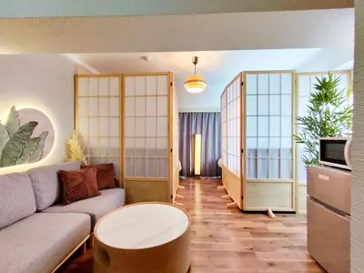 a living room with a couch and a table at G51\u65b0\u5bbf\u6700\u4e2d\u5fc3 \u6771\u65b0\u5bbf\u7ad95\u5206-Shinjuku center 5 mins to Station, Max 4P \u65b0\u5bbf \u6d89\u8c37 \u8868\u53c2\u9053 \u6c60\u888b \u4e0a\u91ce \u4ee3\u4ee3\u6728 \u94f6\u5ea7 \u539f\u5bbf in Tokyo