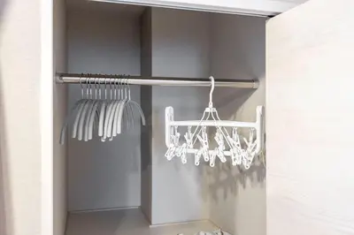 a closet with a white rack with a white chandelier at Mat Hikifune in Tokyo