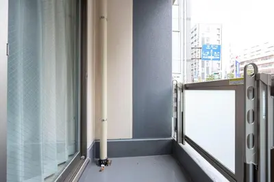 a room with a window with a pipe at Mat Hikifune in Tokyo