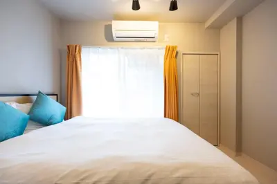 a bedroom with a white bed and a window at Mat Hikifune in Tokyo
