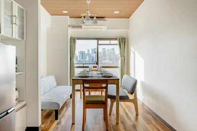 a small dining room with a table and a window at Shinjuku 10min Top FL Apartment -3min to Sta -Max6ppl 3bd in Tokyo