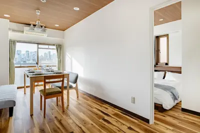 a bedroom with a dining room table and a bed at Shinjuku 10min Top FL Apartment -3min to Sta -Max6ppl 3bd in Tokyo