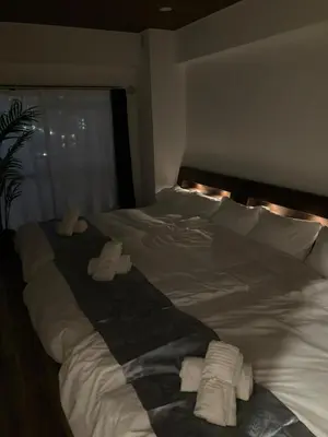 a large white bed with two folded towels on it at Shinjuku 10min Top FL Apartment -3min to Sta -Max6ppl 3bd in Tokyo