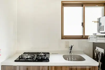 a kitchen with a stove and a sink at Shinjuku 10min Top FL Apartment -3min to Sta -Max6ppl 3bd in Tokyo