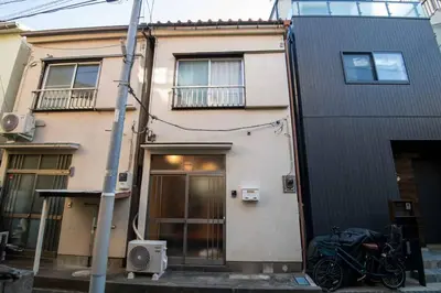 a building with a motorcycle parked in front of it at Cozy Home YOTSUGI tokyo down town in Tokyo