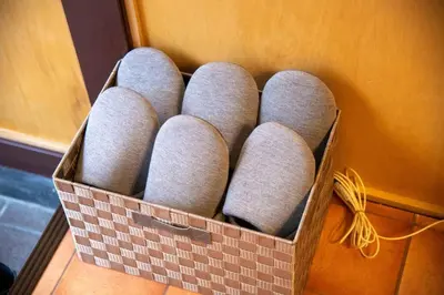 a box filled with gray muffins sitting on a table at Cozy Home YOTSUGI tokyo down town in Tokyo