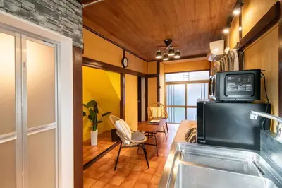 a room with a television and a living room with chairs at Cozy Home YOTSUGI tokyo down town in Tokyo