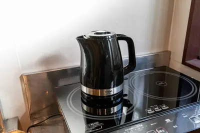 a coffee pot sitting on top of a stove at Cozy Home YOTSUGI tokyo down town in Tokyo