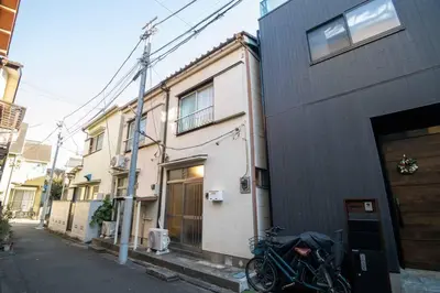 a motorcycle parked in front of a building at Cozy Home YOTSUGI tokyo down town in Tokyo