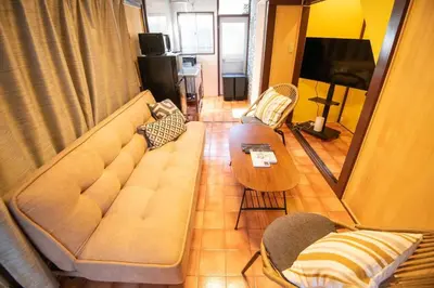 a living room with a couch and a table at Cozy Home YOTSUGI tokyo down town in Tokyo