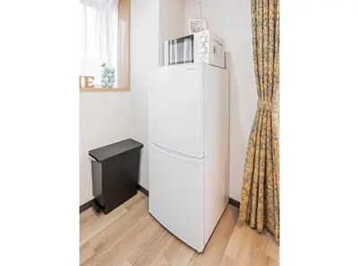 a white refrigerator in a room next to a window at Fukuei Stay Tokyo in Tokyo