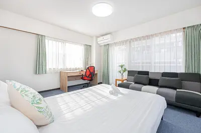 a hotel room with a bed and a couch at Fukuei Stay Tokyo in Tokyo