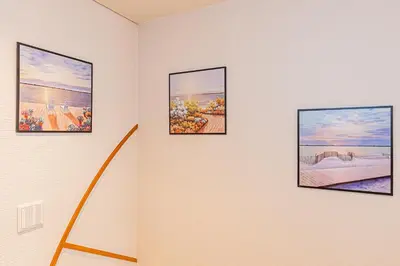 four pictures on a wall in a room at Fukuei Stay Tokyo in Tokyo