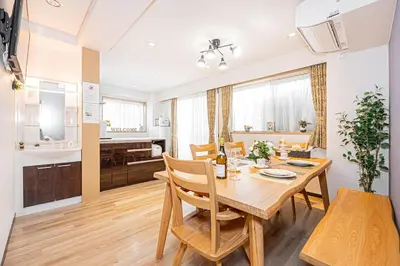 a dining room and kitchen with a table and chairs at Fukuei Stay Tokyo in Tokyo