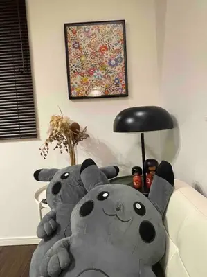 two stuffed animals sitting on a table next to a lamp at Tanuki Shinjuku in Tokyo
