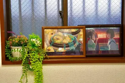 a picture in a window with a painting on it at [空港直接アクセス] JR山手線日暮里駅徒歩8分アパートメント/千駄木ハウス in Tokyo