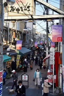 a group of people walking down a busy street at [空港直接アクセス] JR山手線日暮里駅徒歩8分アパートメント/千駄木ハウス in Tokyo