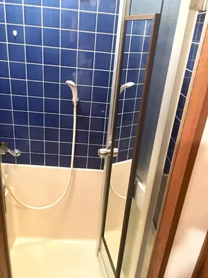 a bathroom with a shower with blue tiles at 10 minutes direct to Shibuya Crossing! Heart of Tokyo! Kamiuma in Tokyo
