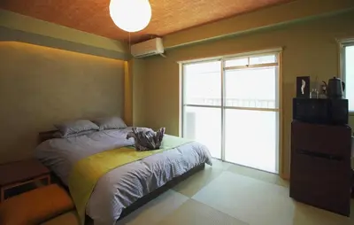 a bedroom with a bed and a large window at \u62b9\u8336\u5eb5\u4e16\u7530\u8c37\u6771\u4eac Matcha-An Setagaya Tokyo in Tokyo