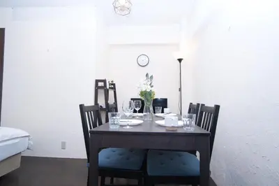 a dining room table with chairs and glasses on it at Yutaka bldg.302 in Tokyo