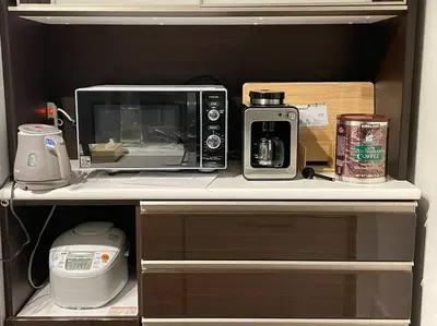 a microwave sitting on top of a kitchen counter at Tanuki Shinjuku 2 in Tokyo