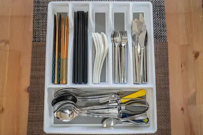 a plastic container filled with utensils on a table at Jujo house Direct to Shinjuku in Tokyo