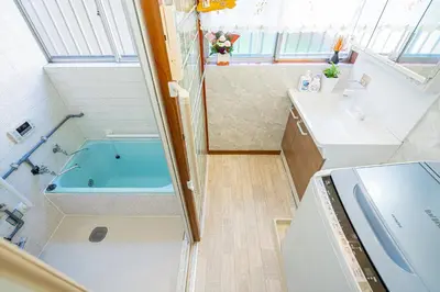 a bathroom with a tub and a sink at Jujo house Direct to Shinjuku in Tokyo