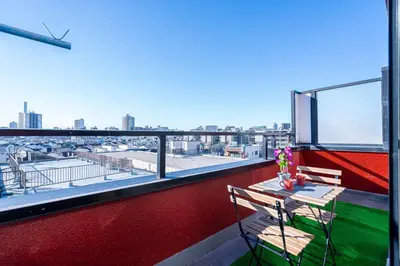 a balcony with a table and a view of a city at Aurora 5 in Tokyo