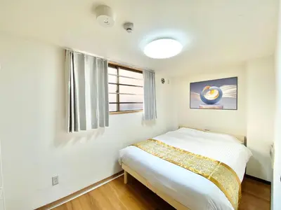 a white bedroom with a bed and a window at Asakusa\u6b63\u548cHouse in Tokyo
