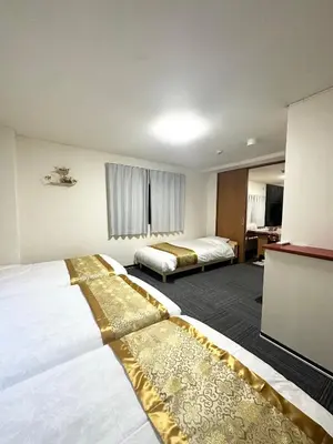 a hotel room with two beds and a desk at Asakusa\u6b63\u548cHouse in Tokyo