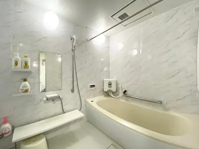 a white bathroom with a tub and a sink at Asakusa\u6b63\u548cHouse in Tokyo