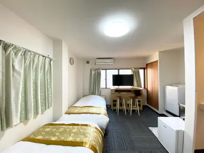 a hotel room with two beds and a desk at Asakusa\u6b63\u548cHouse in Tokyo