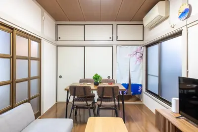 a dining room with a table and chairs and windows at \u795e\u8c37\u6238\u5efa in Tokyo