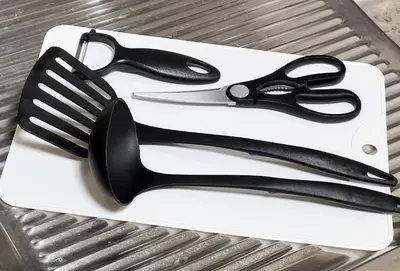 a pair of scissors on a white cutting board at \u795e\u8c37\u6238\u5efa in Tokyo