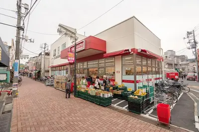 a store on a street with people standing in front of it at 押上·晴空塔·浅草寺商圈ろ隅田川附近/豪华家庭套房/机场直达/new一户建&小型停车位/可接送地铁站 in Tokyo