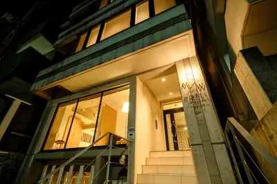 a front door of a building at night at M/W HOTEL in Tokyo