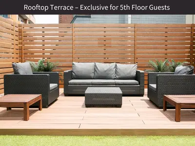 a patio with two couches and a table and benches at M/W HOTEL in Tokyo