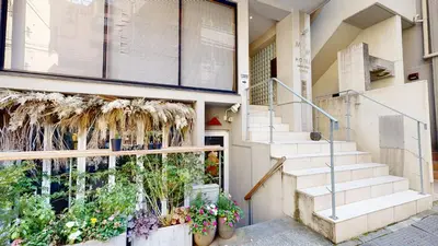 a building with stairs and flowers in front of it at M/W HOTEL in Tokyo