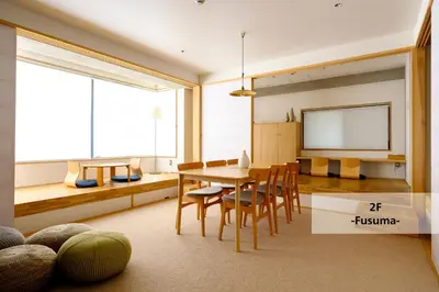 a dining room with a table and chairs and a tv at M/W HOTEL in Tokyo