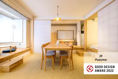 a dining room with a table and a bed at M/W HOTEL in Tokyo