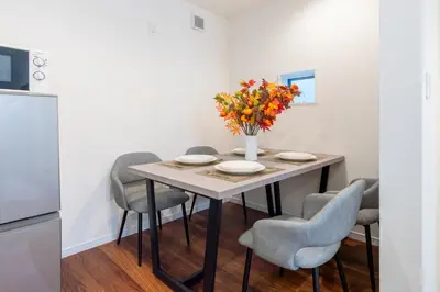 a dining room table with chairs and a vase of flowers at \u5343\u99c4\u6728\u6238\u5efa in Tokyo