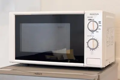 a microwave oven sitting on top of a shelf at \u5343\u99c4\u6728\u6238\u5efa in Tokyo