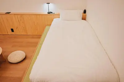 a large white bed in a room at HERE.Tokyo in Tokyo