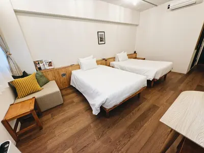 a room with two beds and a couch at HERE.Tokyo in Tokyo