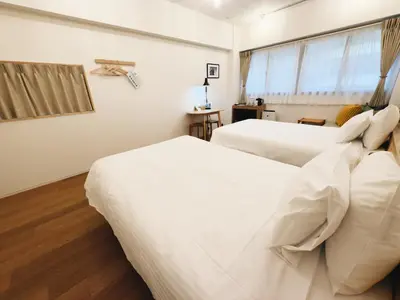 two white beds in a room with a window at HERE.Tokyo in Tokyo