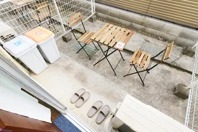 an overhead view of a table and benches and two trash cans at SC 102 Cozy Private Stay with Loft Near Station Free WiFi in Tokyo