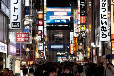 a crowd of people walking in a busy city at night at \u672b\u677e\u30d3\u30eb -Tokyo lifestyle apartment- in Tokyo