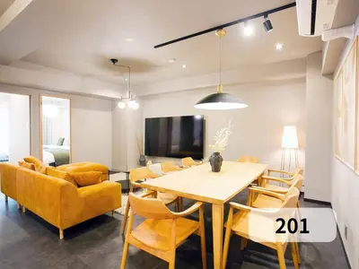 a dining room and living room with a table and chairs at \u672b\u677e\u30d3\u30eb -Tokyo lifestyle apartment- in Tokyo