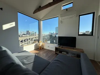 a living room with a couch and large windows at \u6795\u6728 New house with Huge View for Family-Group in Tokyo